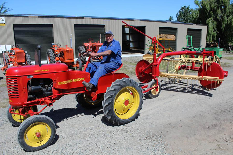 Ken Barr on his 1949 Massey Harris 30 towing a 1952 Massey Harris hay rake