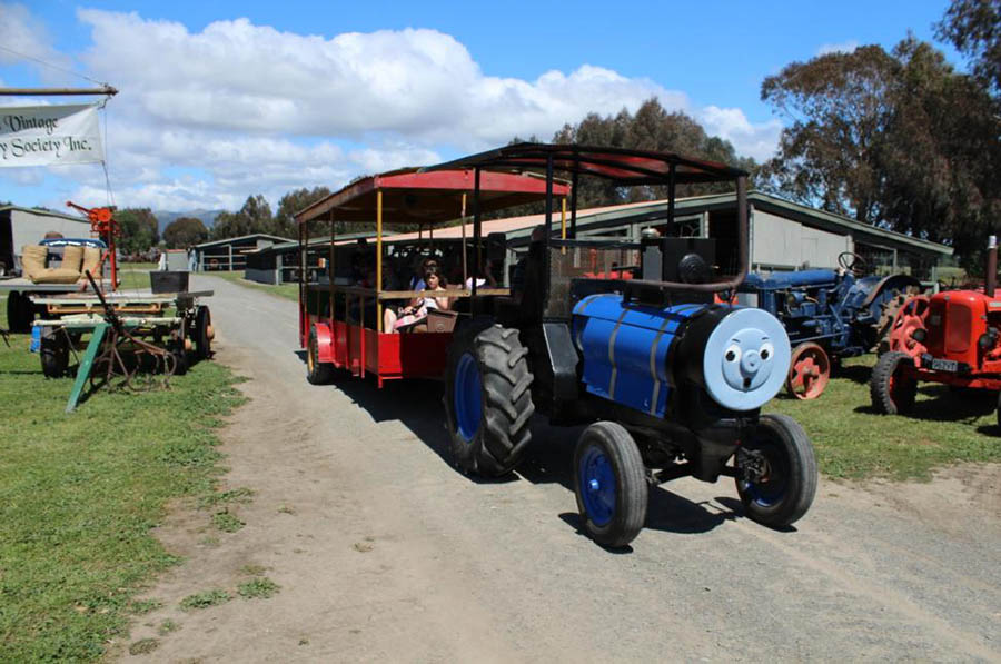 The kids love to take a ride around the park with a friendly looking tractor